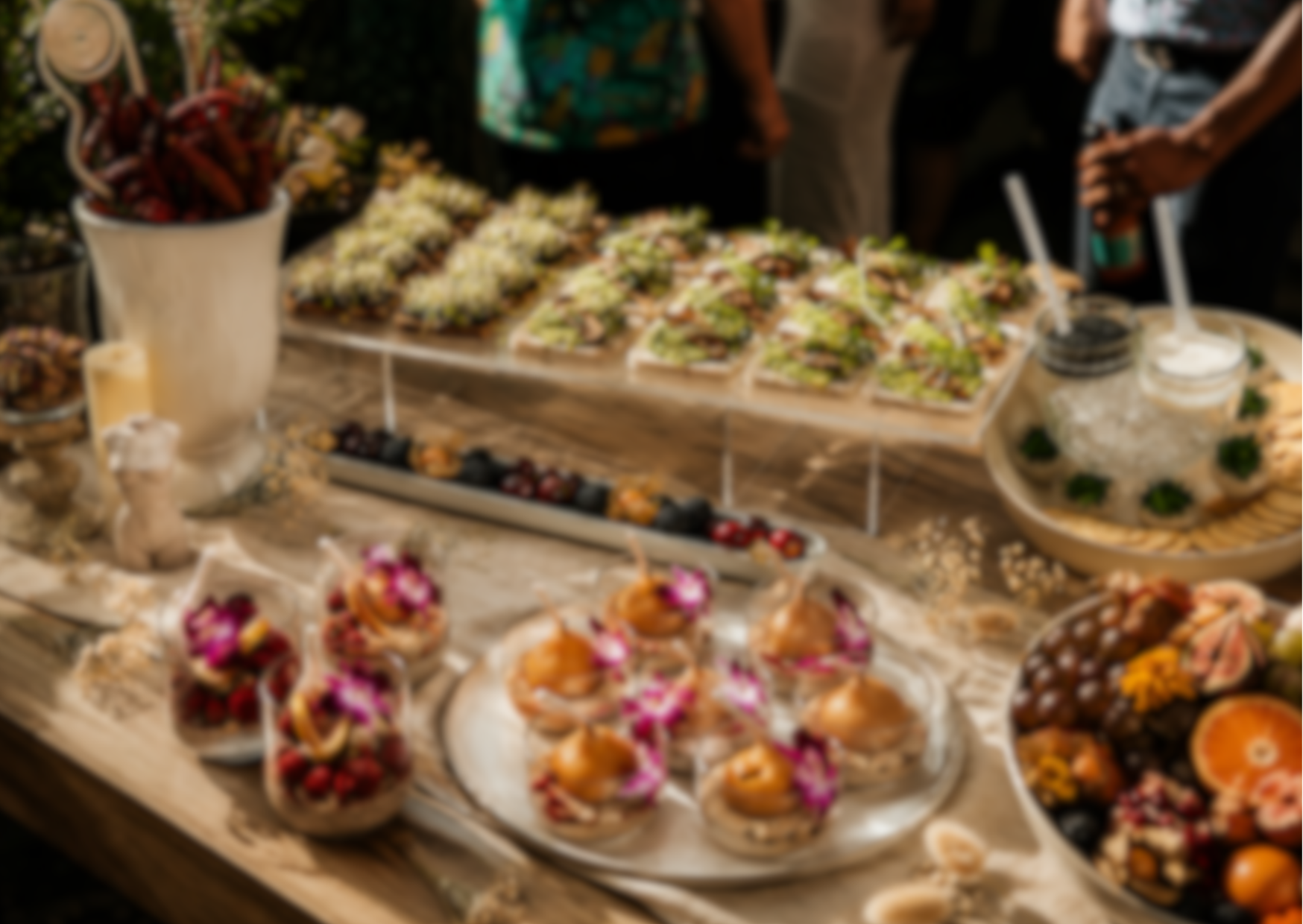 Buffet table with various dishes including small cakes and garnished plates.